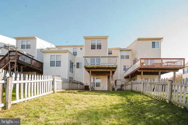 a view of houses with deck and backyard