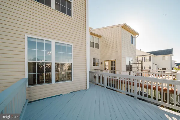 a view of a balcony with wooden floor and fence