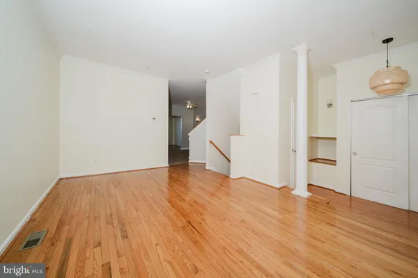 a view of empty room with wooden floor