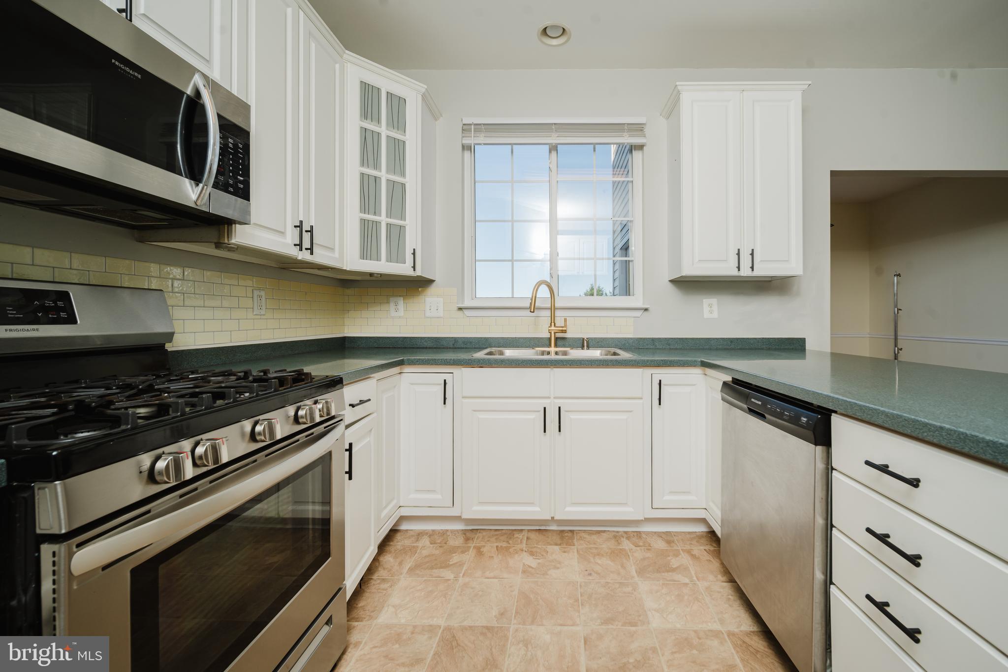 714 Kirkcaldy Way Abingdon, MD 21009 - Photo 6 of 34 a kitchen with granite countertop cabinets stainless steel appliances and a sink