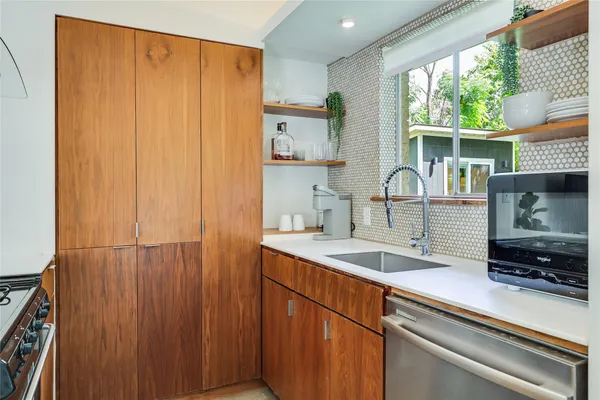 a kitchen with a sink and large window