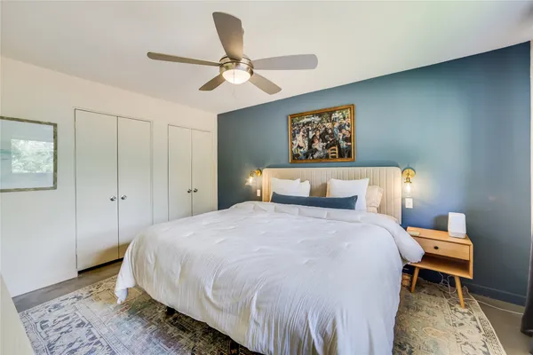 a bedroom with a bed and a chandelier