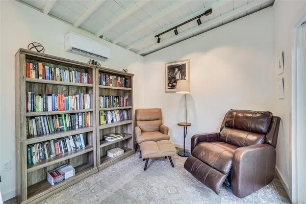 a living room with furniture and a book shelf