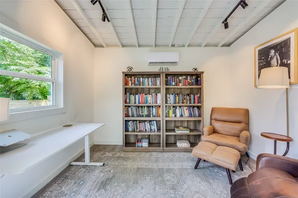 a view of a livingroom with workspace and a couch