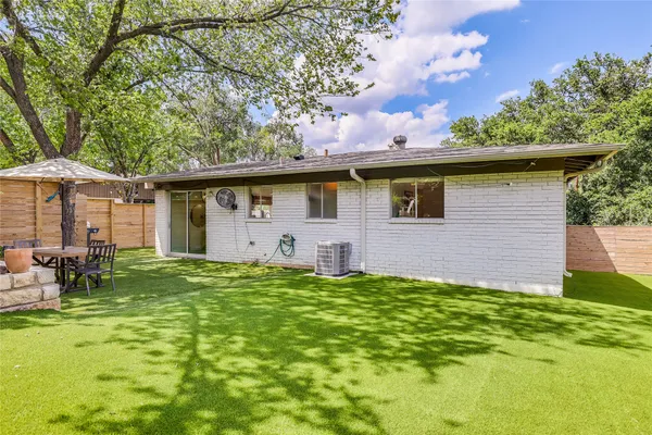 a front view of house with yard and trees