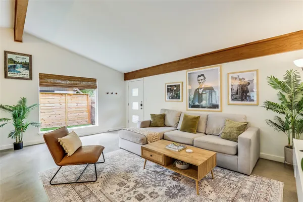 a living room with furniture and wooden floor