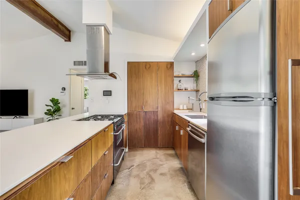 a kitchen with a sink stove and refrigerator