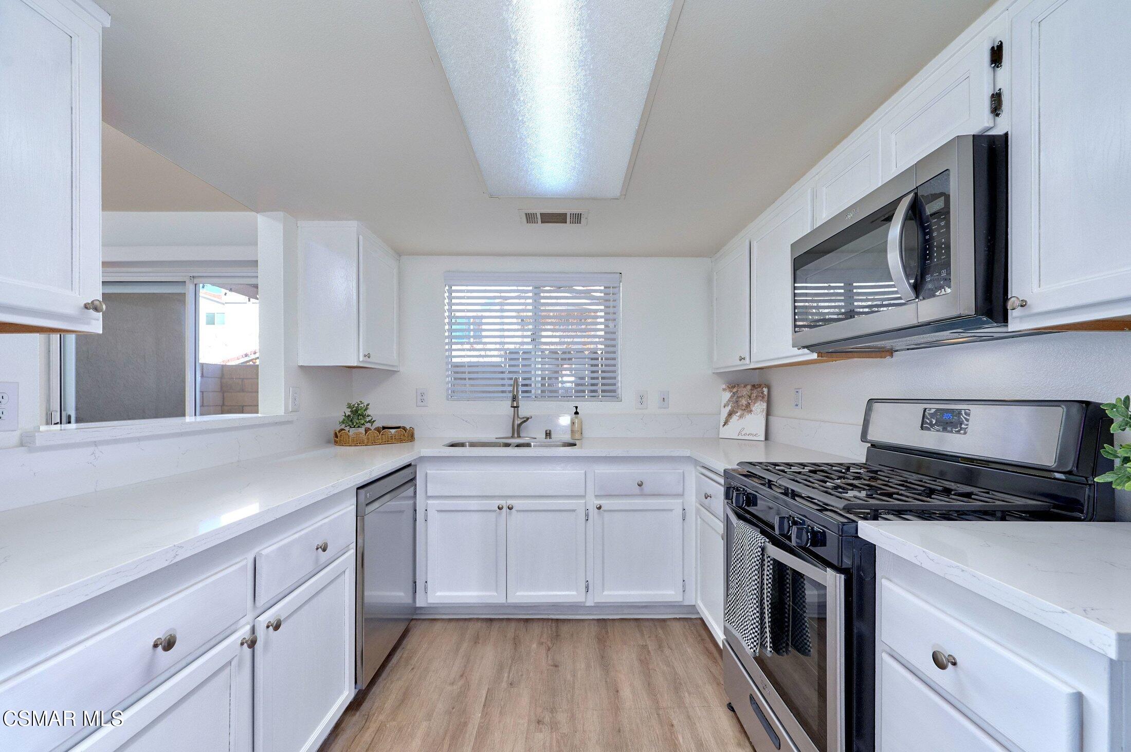 4508 Apricot Road, Unit B Simi Valley, CA 93063 - Photo 13 of 44 a kitchen with stainless steel appliances a sink stove and cabinets