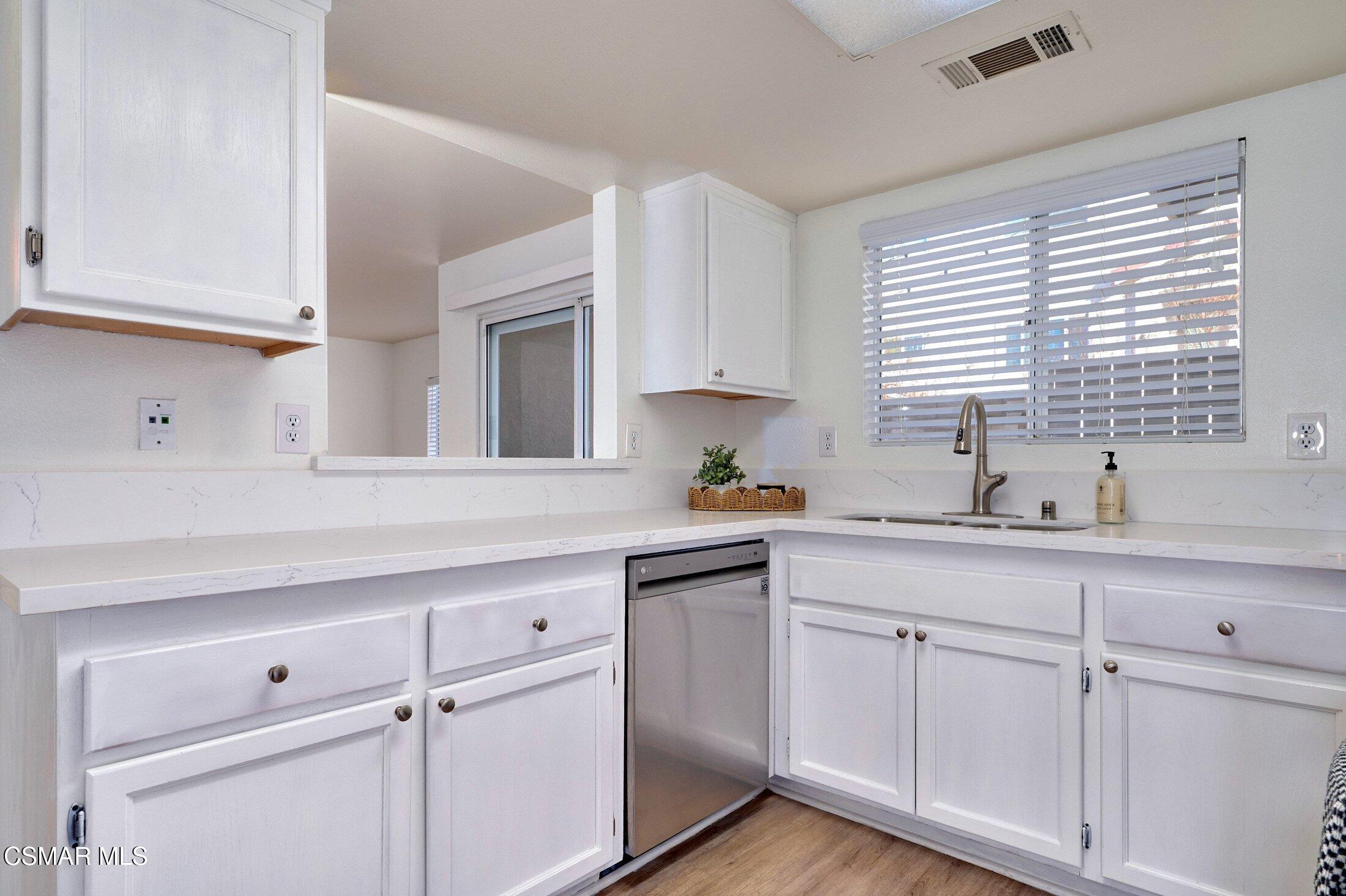 4508 Apricot Road, Unit B Simi Valley, CA 93063 - Photo 15 of 44 a kitchen with white cabinets and a window