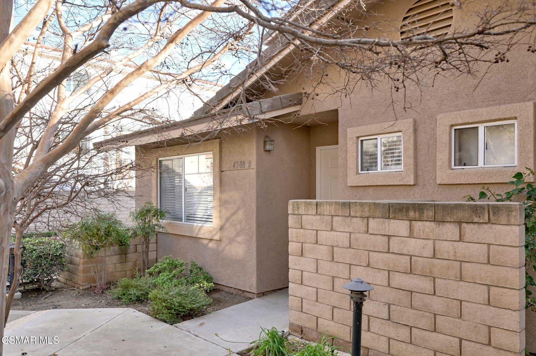 4508 Apricot Road, Unit B Simi Valley, CA 93063 - Photo 2 of 44 a brick house with a tree in front of it