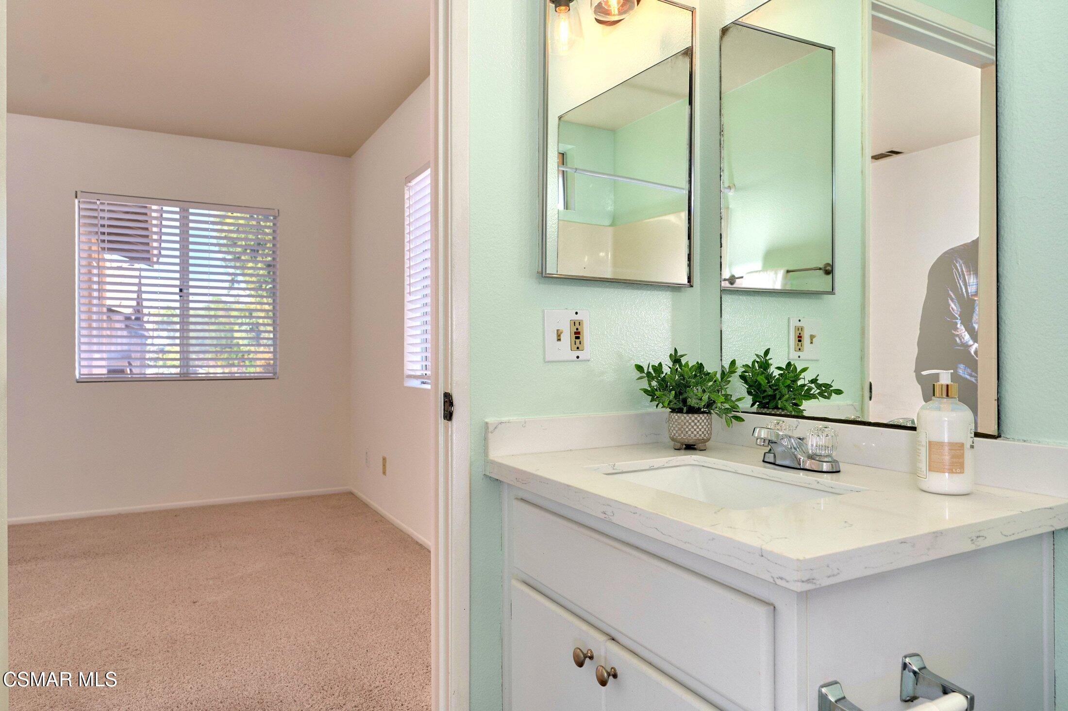 4508 Apricot Road, Unit B Simi Valley, CA 93063 - Photo 24 of 44 a bathroom with a granite countertop sink and a mirror