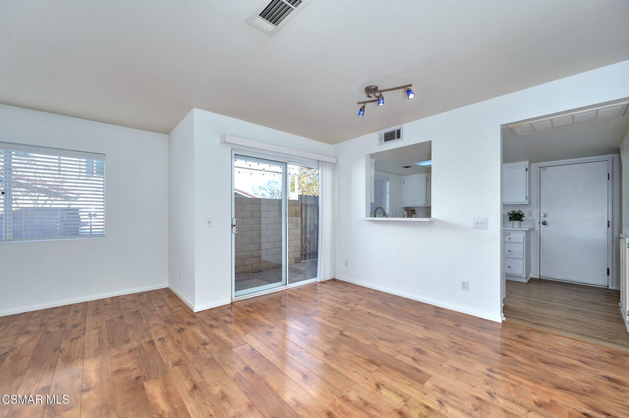 4508 Apricot Road, Unit B Simi Valley, CA 93063 - Photo 10 of 44 a view of an empty room with wooden floor and a ceiling fan