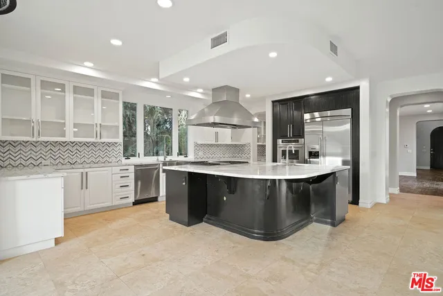 a kitchen with stainless steel appliances granite countertop a stove and a sink