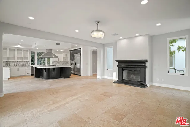 a view of a kitchen with a sink and a fireplace
