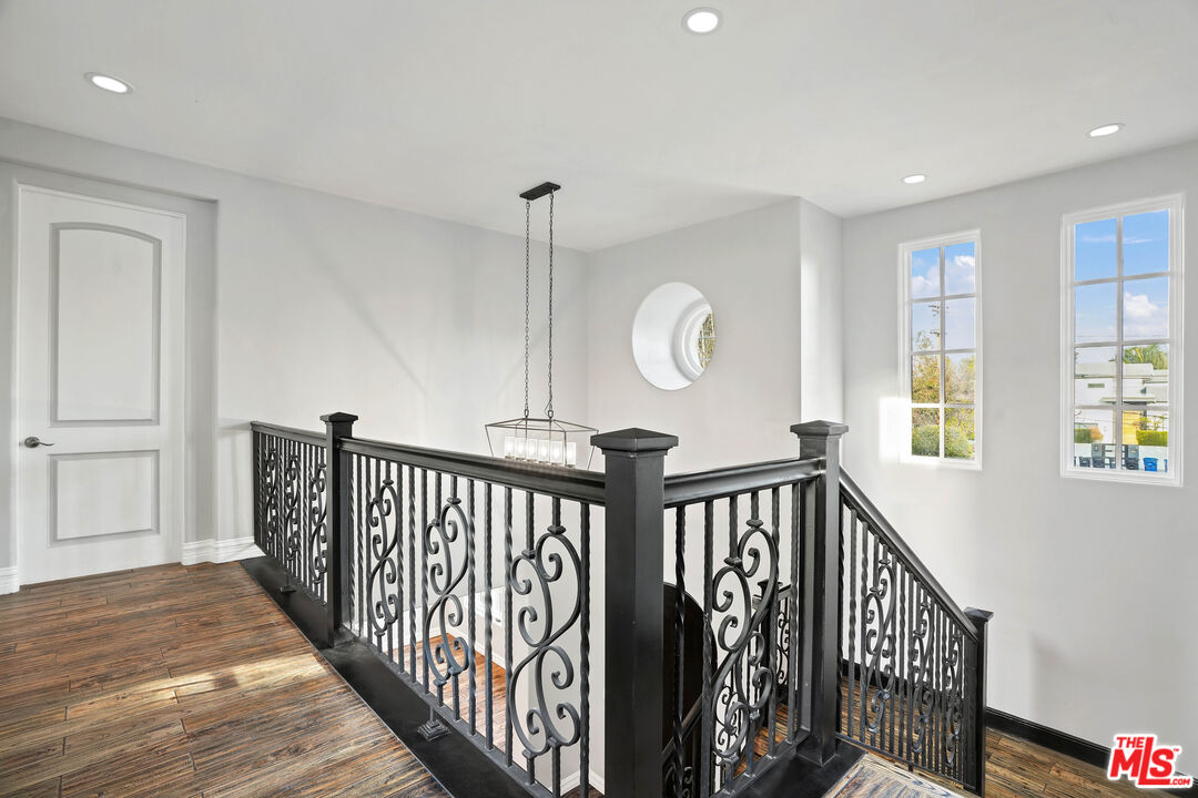 5309 Louise Avenue Encino, CA 91316 - Photo 16 of 38 a view of a hallway with wooden floor and stairs