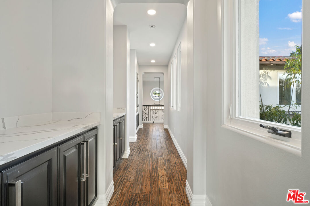 5309 Louise Avenue Encino, CA 91316 - Photo 17 of 38 a view of a hallway with wooden floor and a bathroom