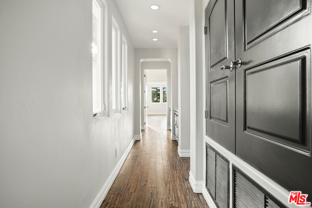 5309 Louise Avenue Encino, CA 91316 - Photo 18 of 38 a view of a hallway with wooden floor and staircase