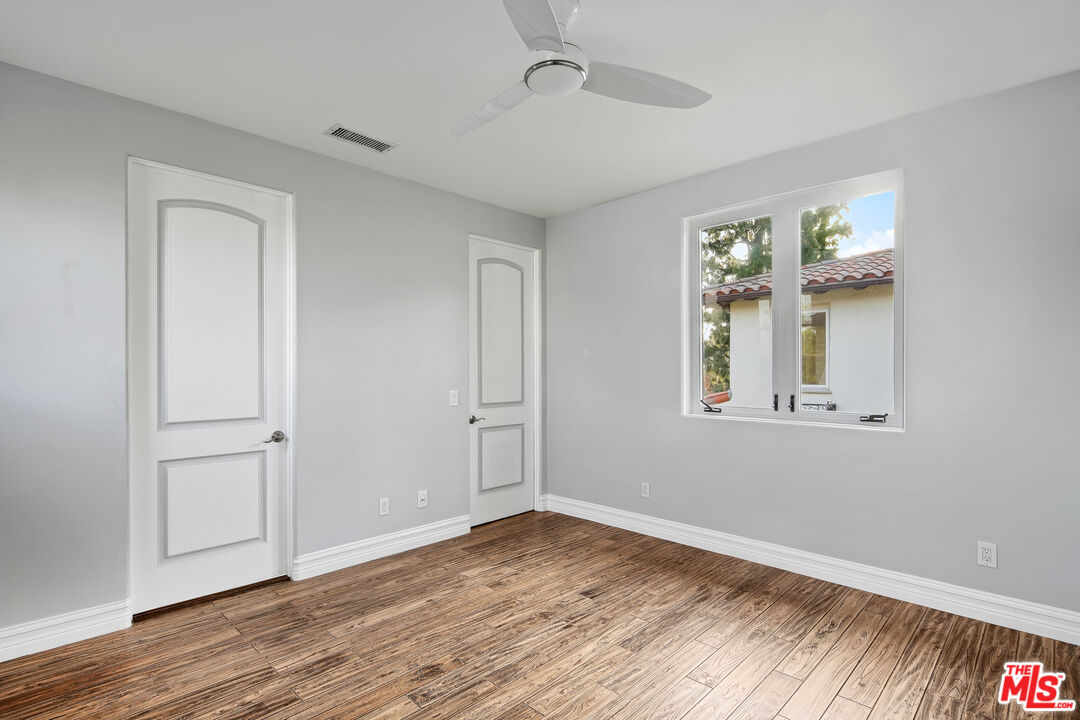 5309 Louise Avenue Encino, CA 91316 - Photo 20 of 38 a view of an empty room with wooden floor and a window