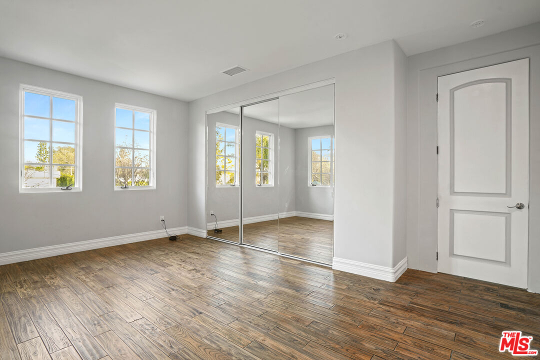5309 Louise Avenue Encino, CA 91316 - Photo 22 of 38 an empty room with wooden floor and windows