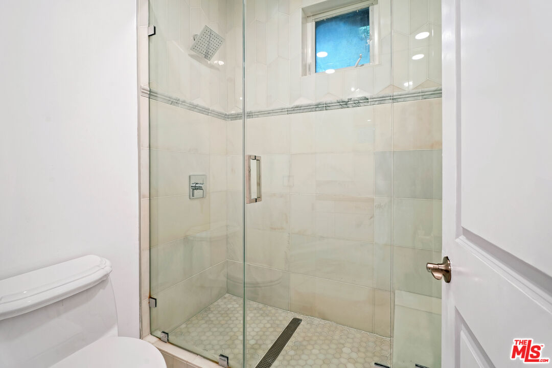 5309 Louise Avenue Encino, CA 91316 - Photo 24 of 38 a bathroom with a shower a toilet and a sink