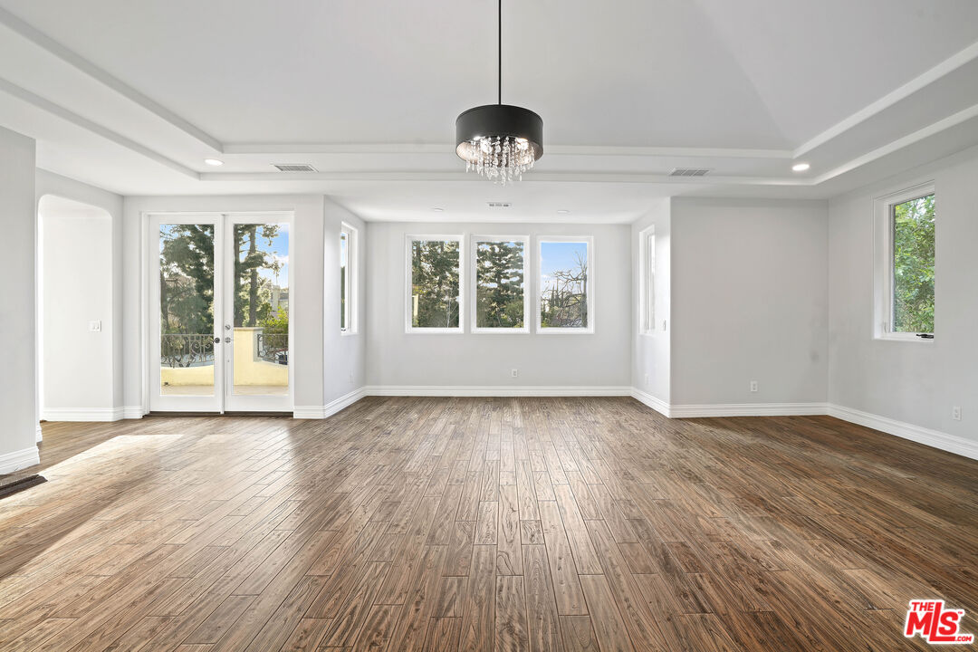 5309 Louise Avenue Encino, CA 91316 - Photo 25 of 38 a view of an empty room with wooden floor and a window