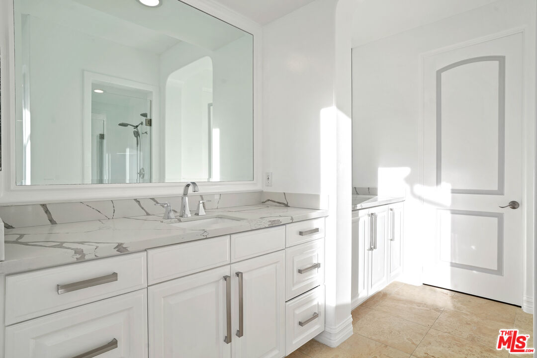 5309 Louise Avenue Encino, CA 91316 - Photo 28 of 38 a bathroom with a double vanity sink and mirror