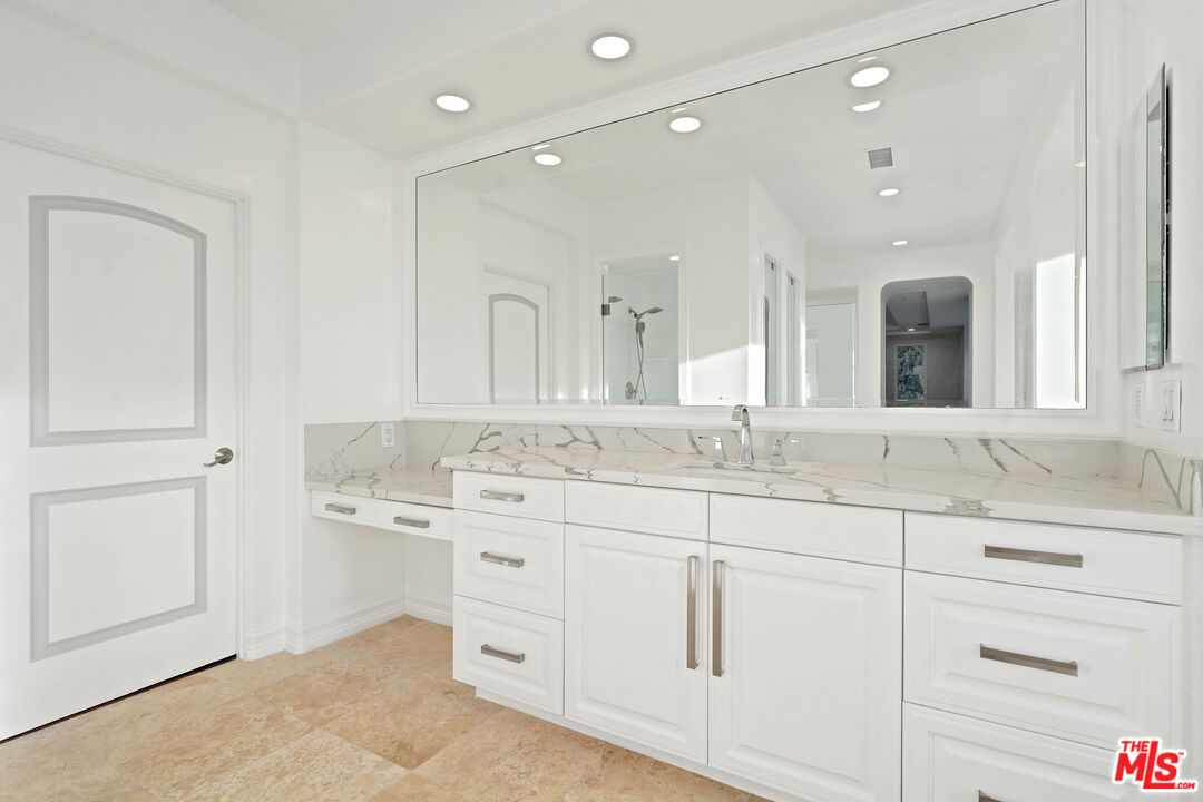 5309 Louise Avenue Encino, CA 91316 - Photo 30 of 38 a bathroom with a granite countertop sink mirror and