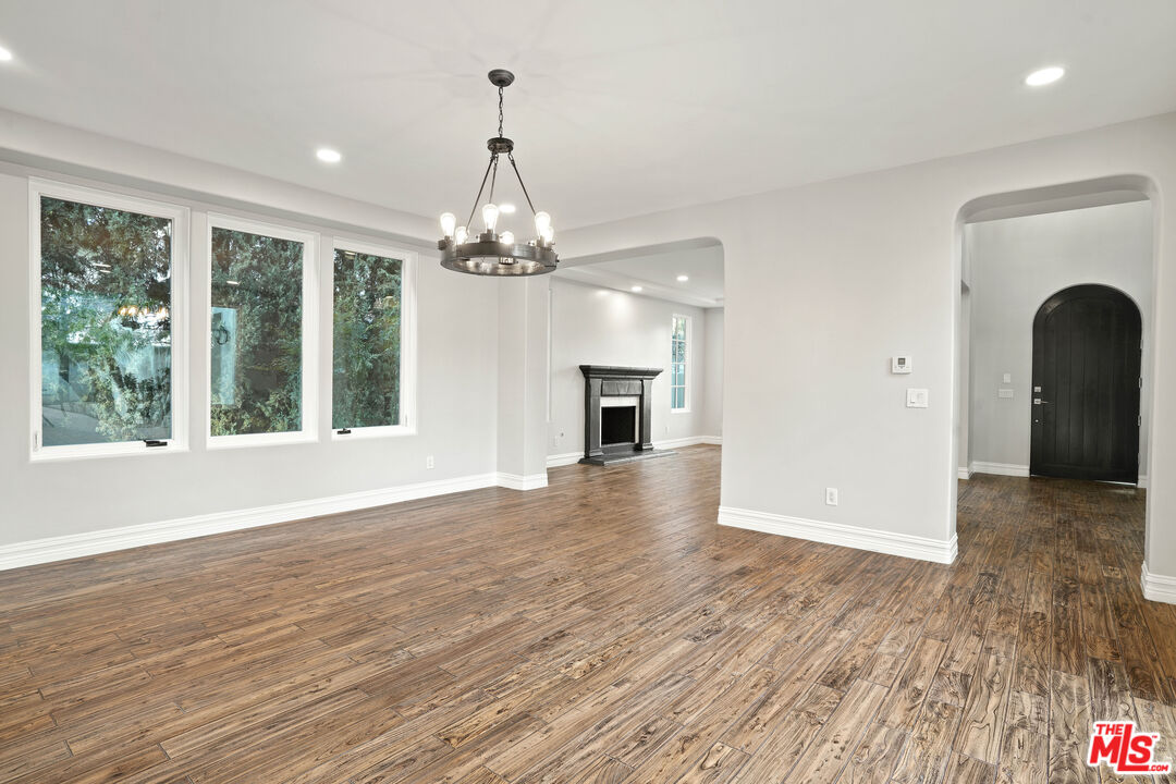 5309 Louise Avenue Encino, CA 91316 - Photo 3 of 38 a view of a livingroom with wooden floor fireplace and a window