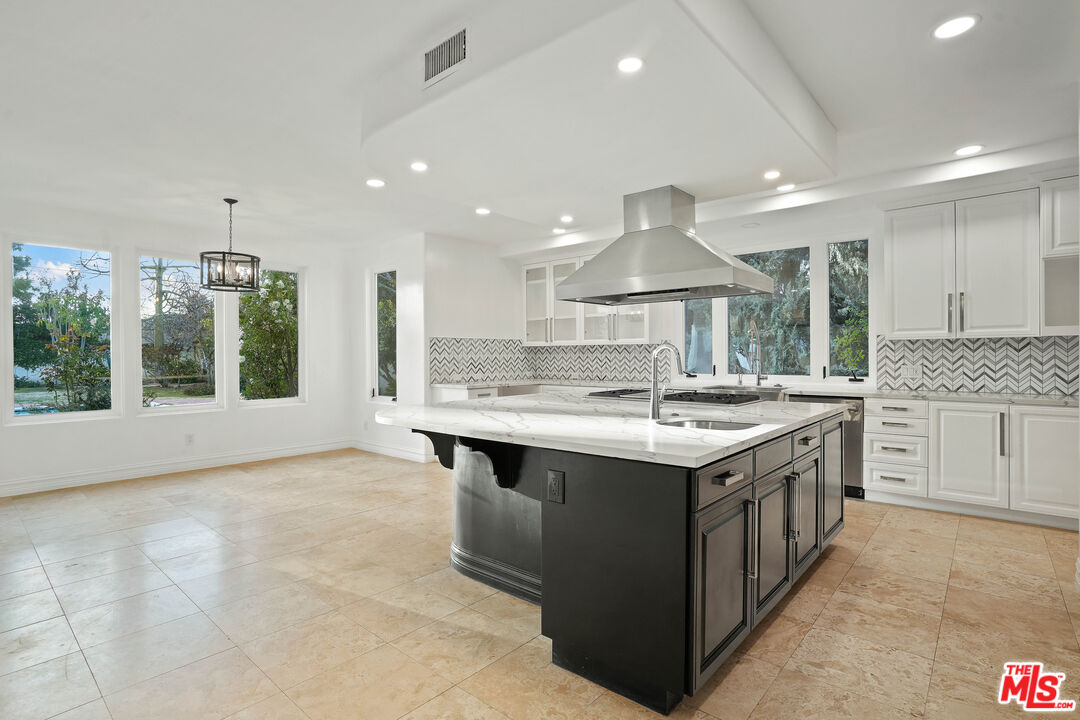 5309 Louise Avenue Encino, CA 91316 - Photo 9 of 38 a kitchen with kitchen island granite countertop a sink stove and cabinets