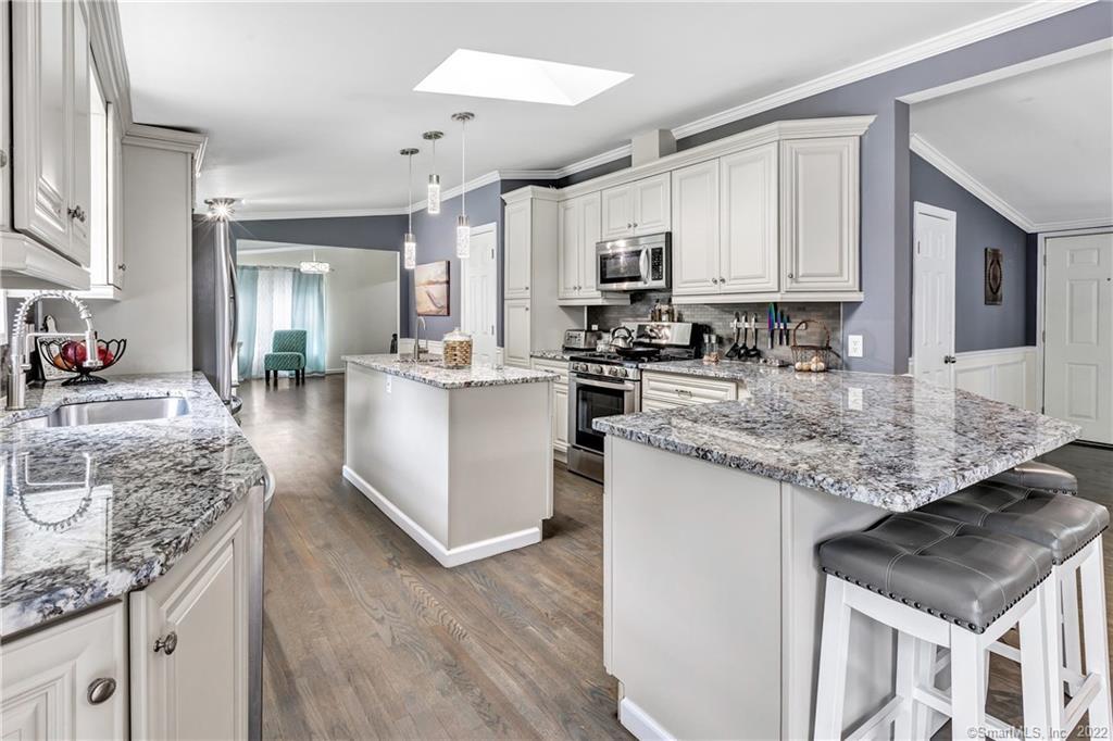 75 Union City Road Naugatuck, CT 06770 - Photo 1 of 1 a kitchen with stainless steel appliances granite countertop a stove top oven a sink dishwasher and cabinets with wooden floor