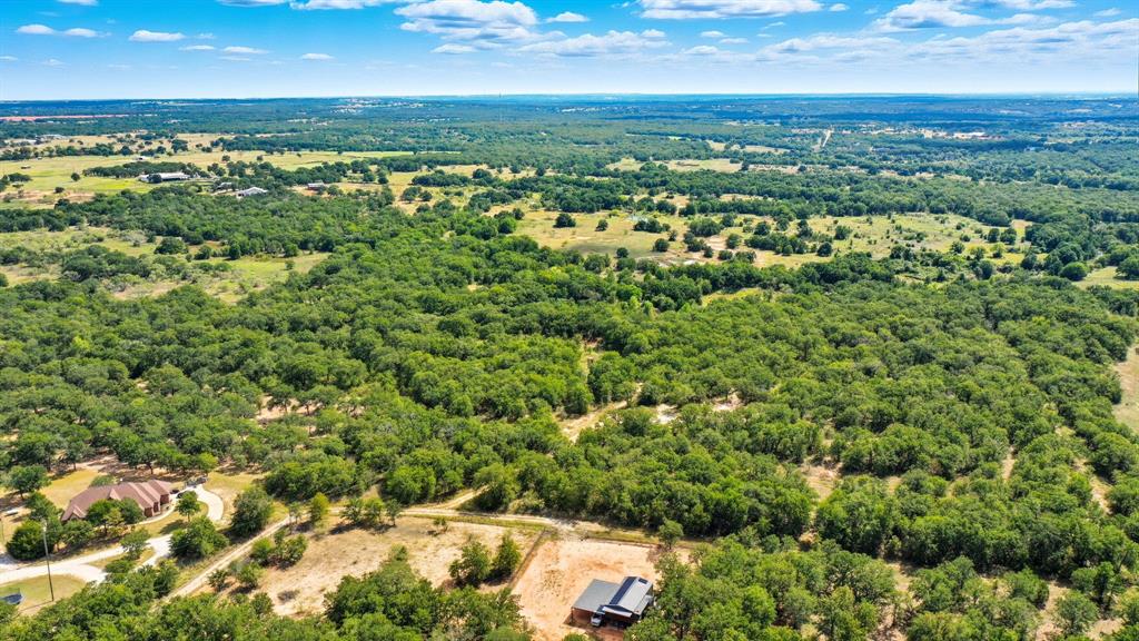 785 Jordan Road Poolville, TX 76487 - Photo 6 of 17 an aerial view of residential houses with outdoor space and trees