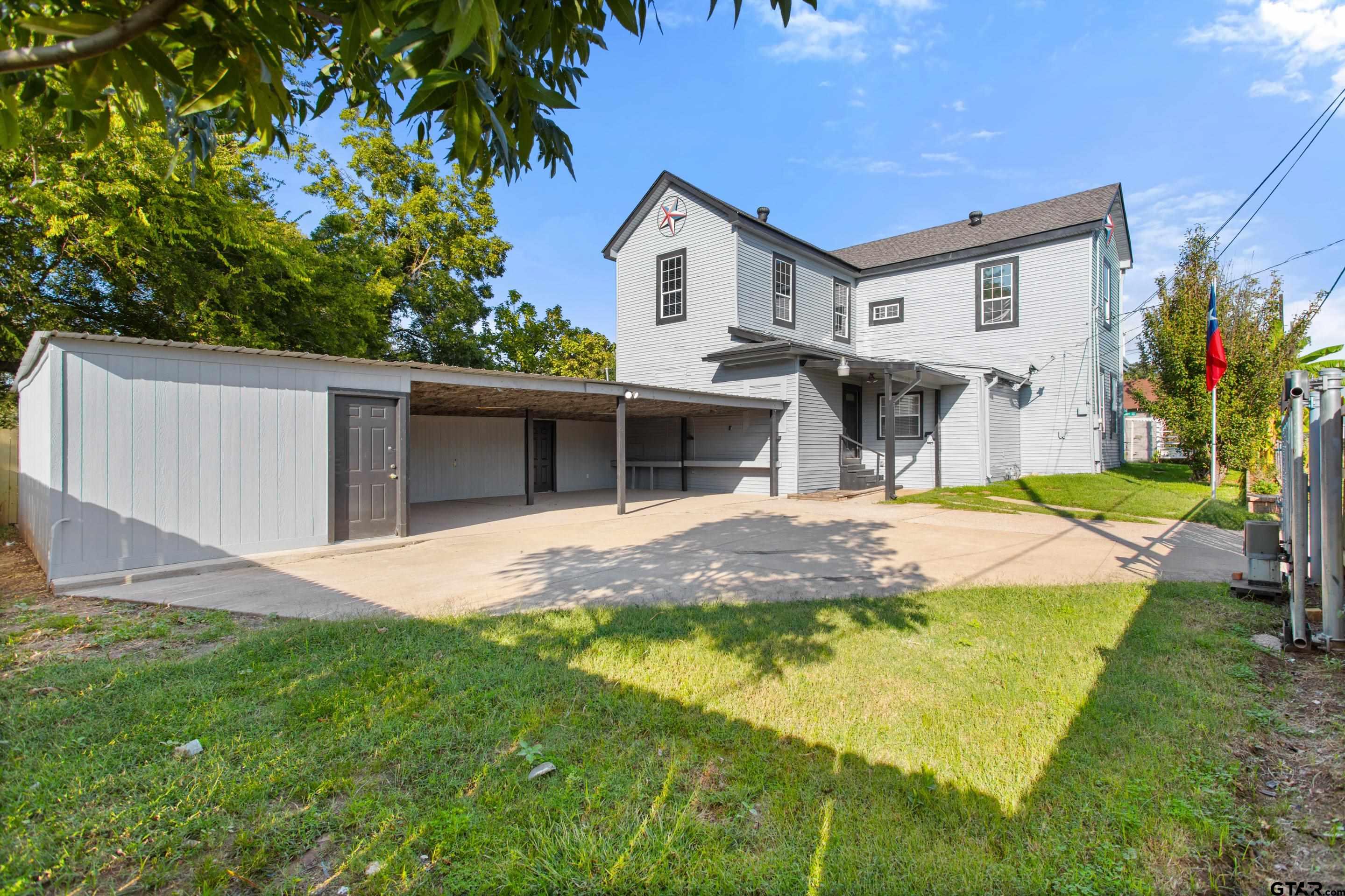 1002 North Normandy Avenue Tyler, TX 75702 - Photo 14 of 41 a view of a house with a yard and porch