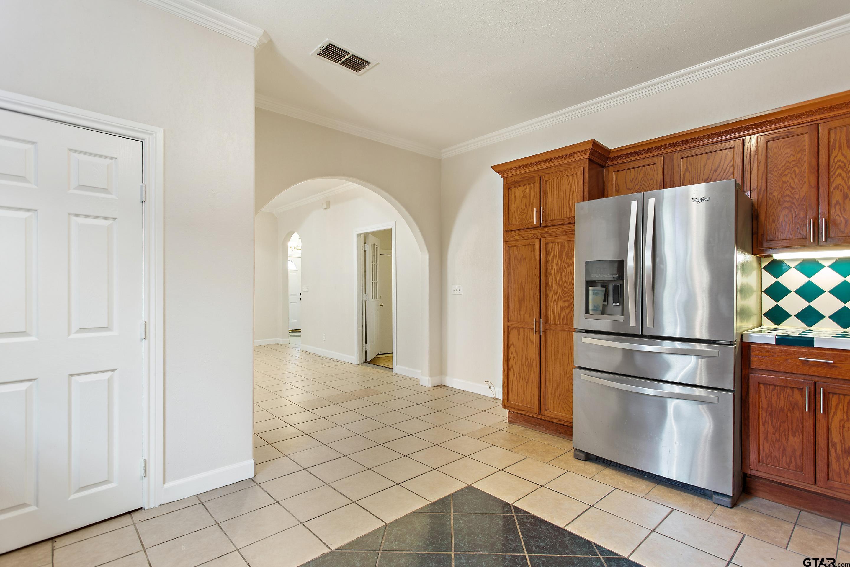 1002 North Normandy Avenue Tyler, TX 75702 - Photo 18 of 41 a kitchen with stainless steel appliances granite countertop a refrigerator and a sink