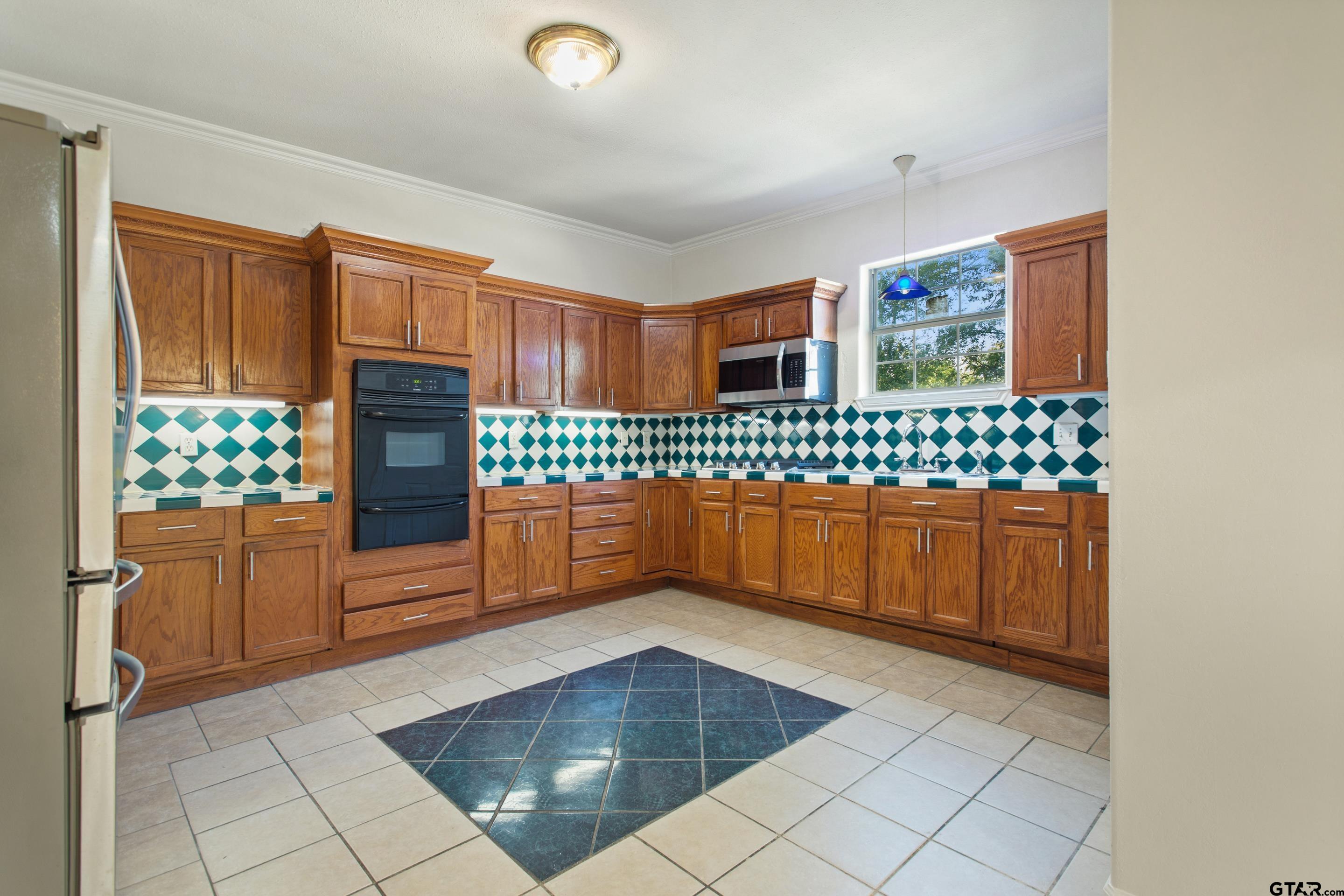 1002 North Normandy Avenue Tyler, TX 75702 - Photo 20 of 41 a kitchen with stainless steel appliances a sink and a cabinets