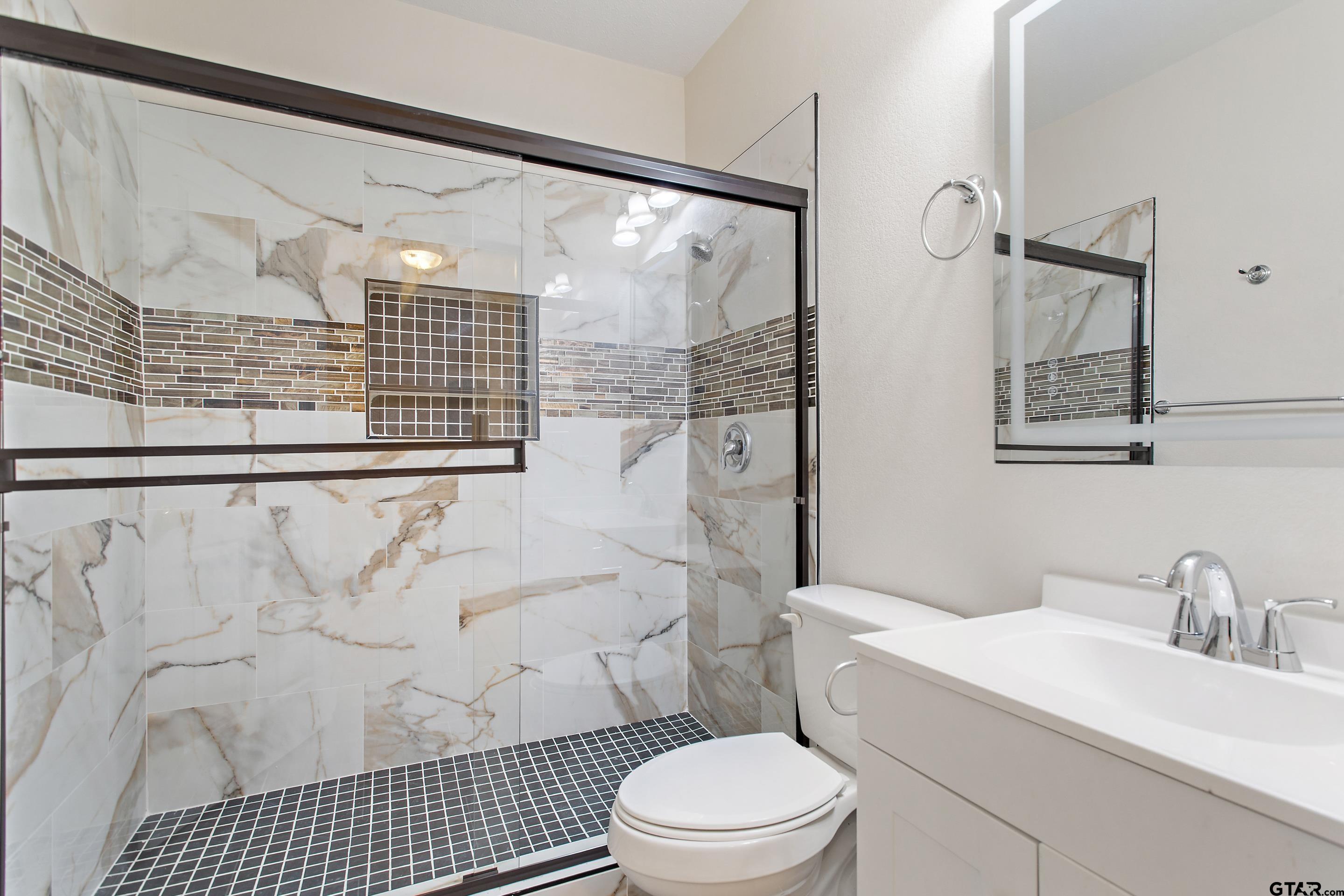 1002 North Normandy Avenue Tyler, TX 75702 - Photo 22 of 41 a bathroom with a sink toilet and shower