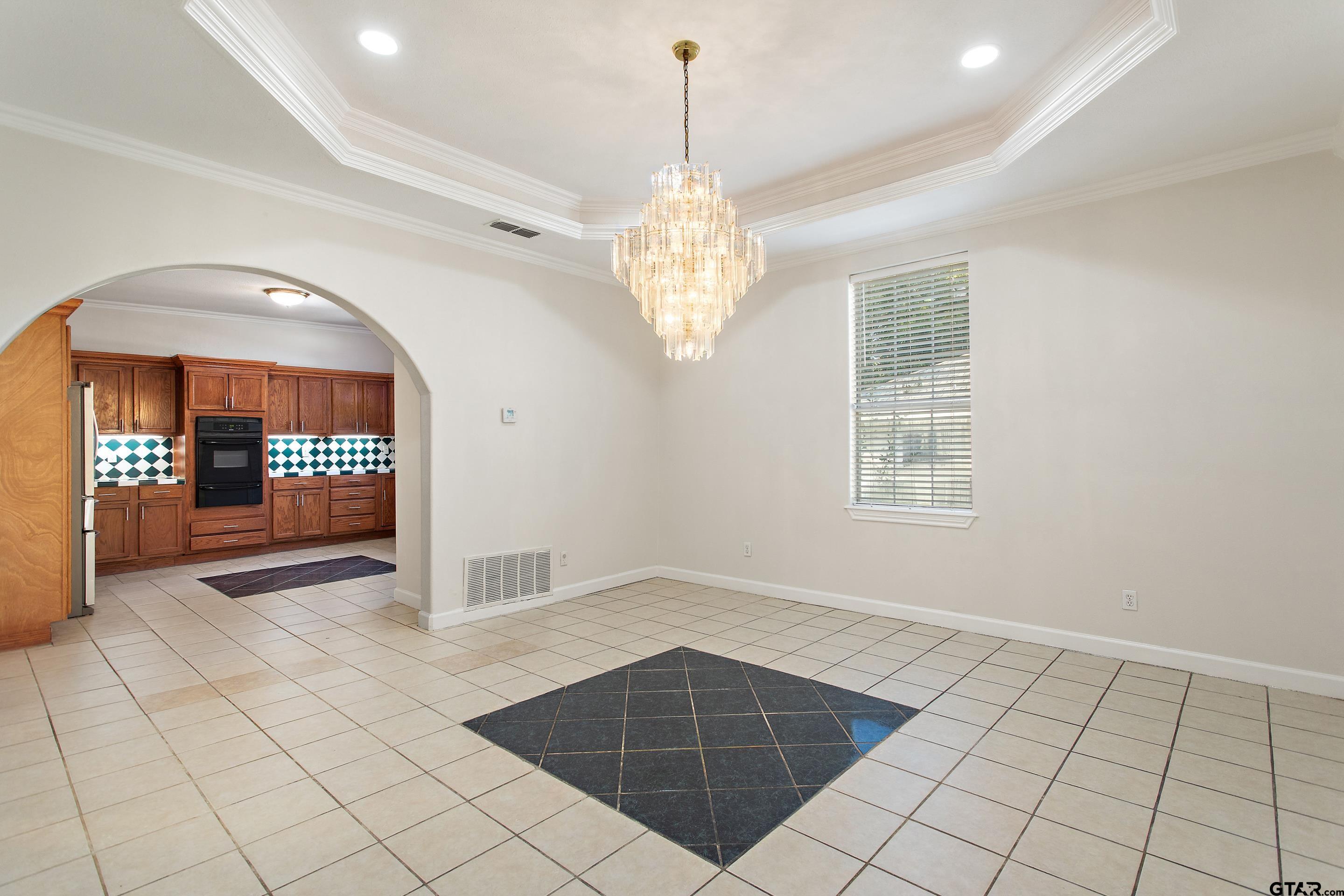 1002 North Normandy Avenue Tyler, TX 75702 - Photo 25 of 41 a view of an empty room with window and chandelier