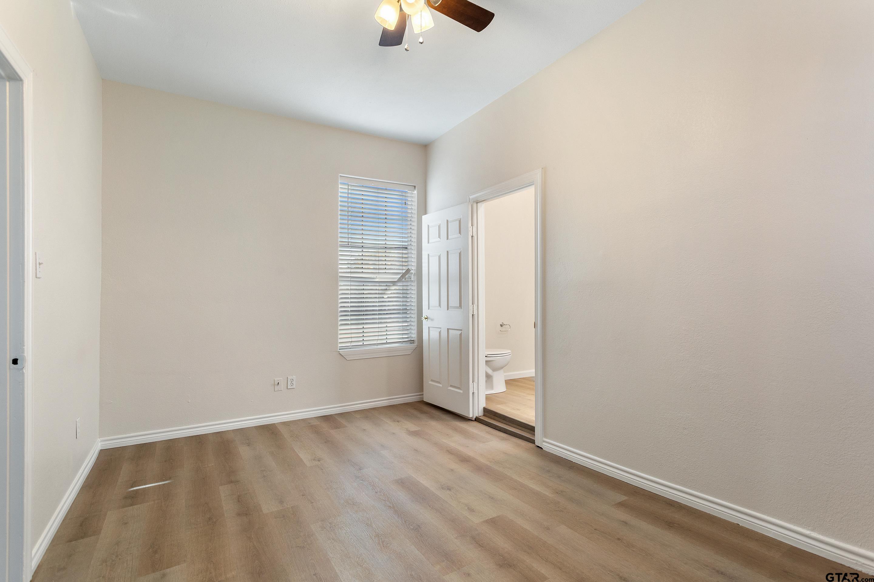 1002 North Normandy Avenue Tyler, TX 75702 - Photo 32 of 41 an empty room with wooden floor cabinet and windows