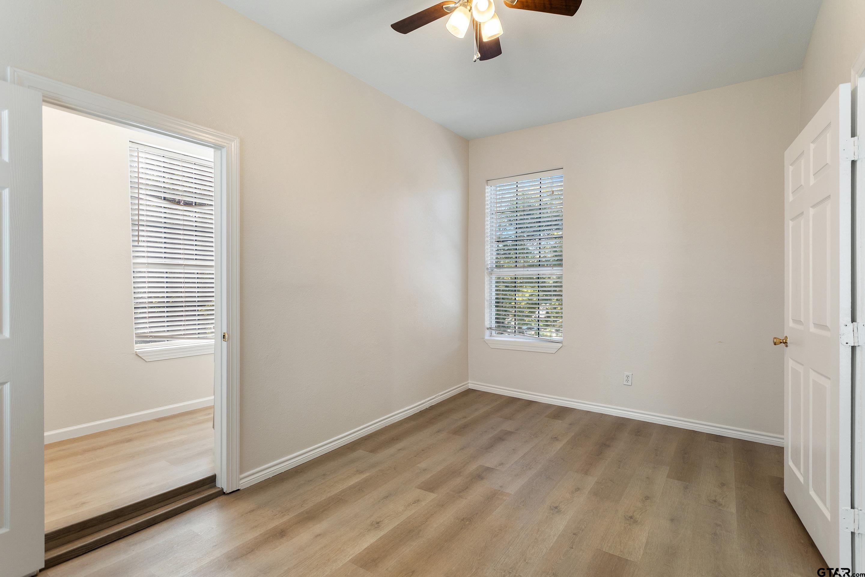 1002 North Normandy Avenue Tyler, TX 75702 - Photo 33 of 41 a view of an empty room with a window and wooden floor