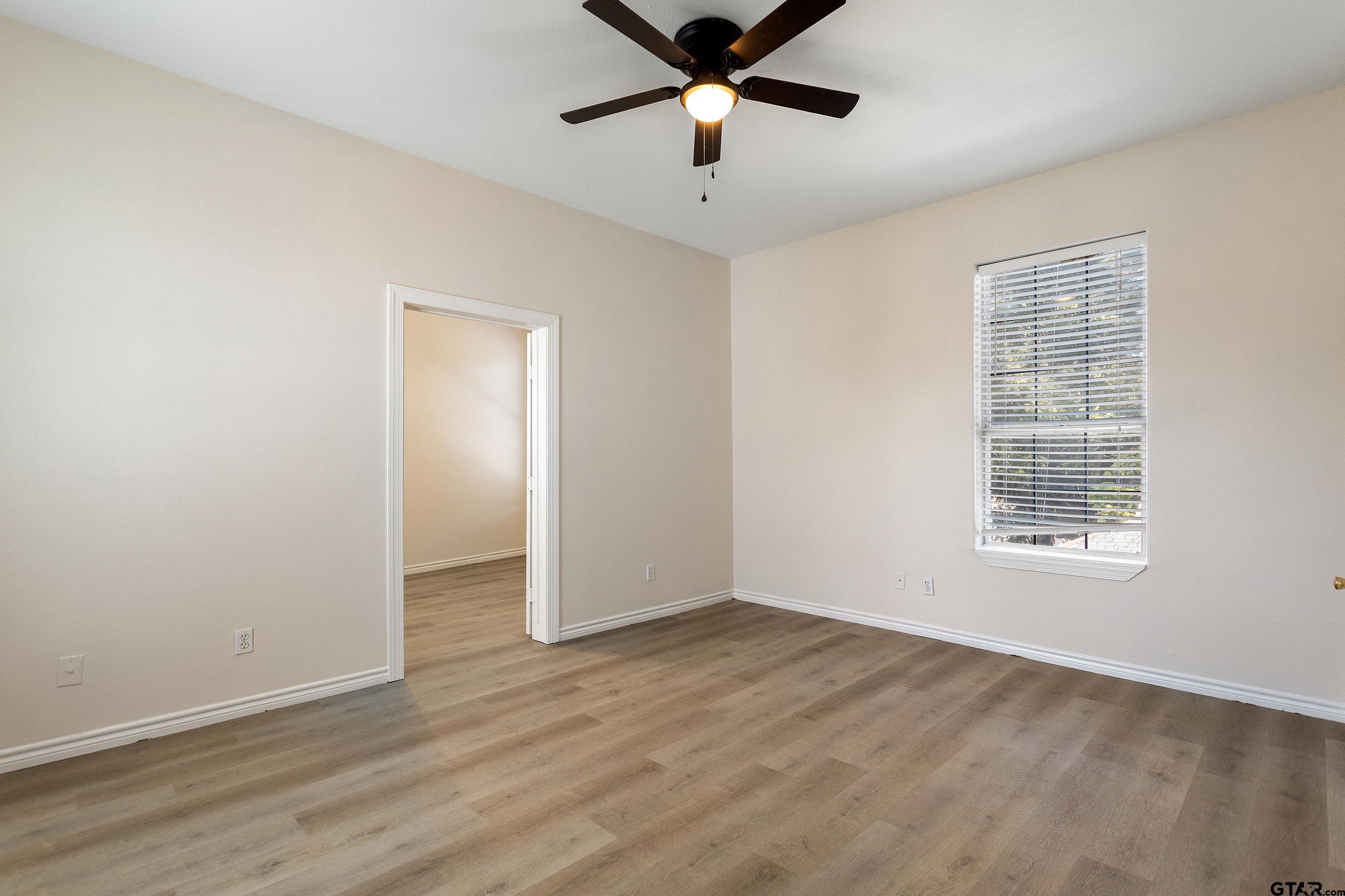 1002 North Normandy Avenue Tyler, TX 75702 - Photo 35 of 41 a view of an empty room with window and a ceiling fan