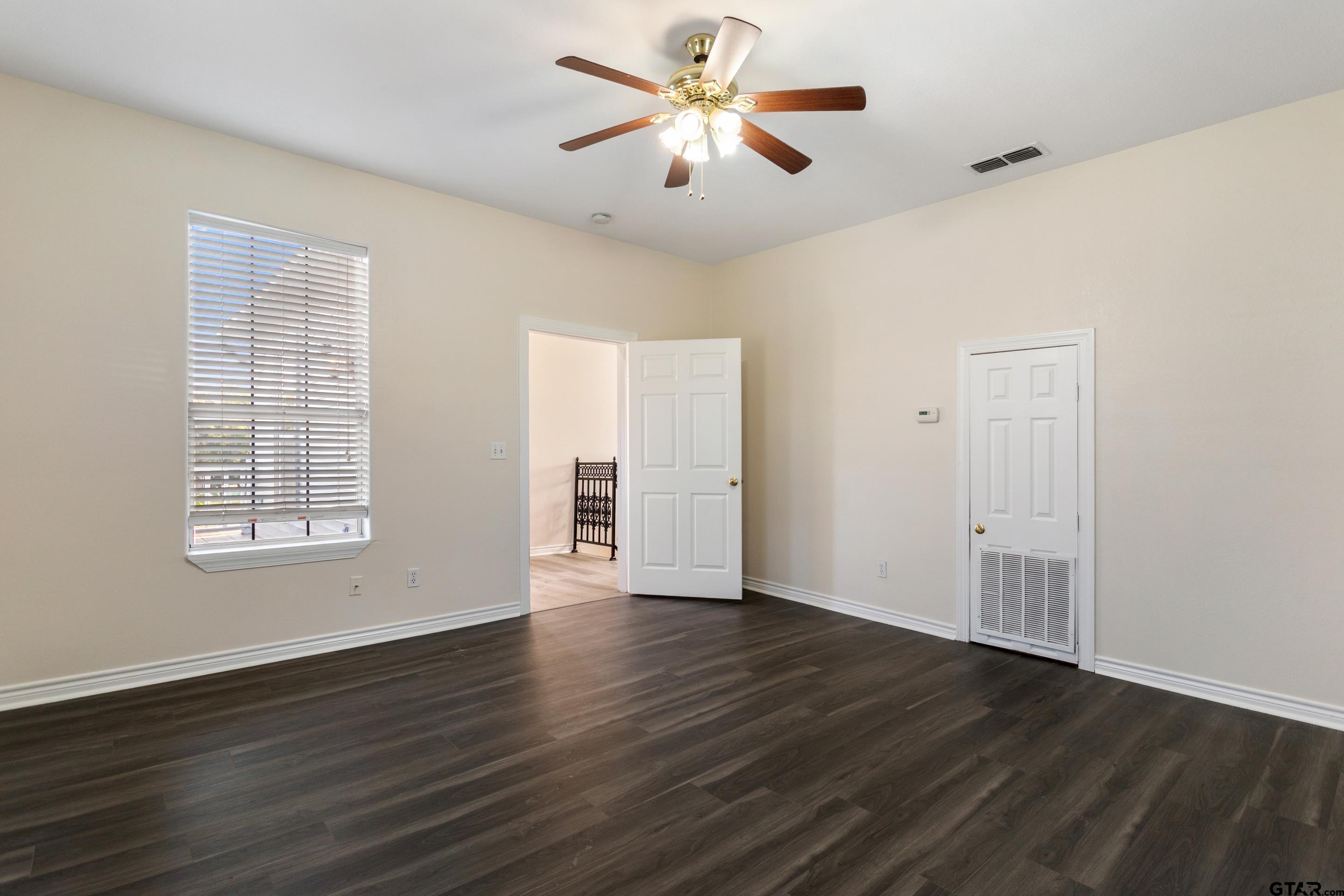 1002 North Normandy Avenue Tyler, TX 75702 - Photo 36 of 41 wooden floor in an empty room with a window