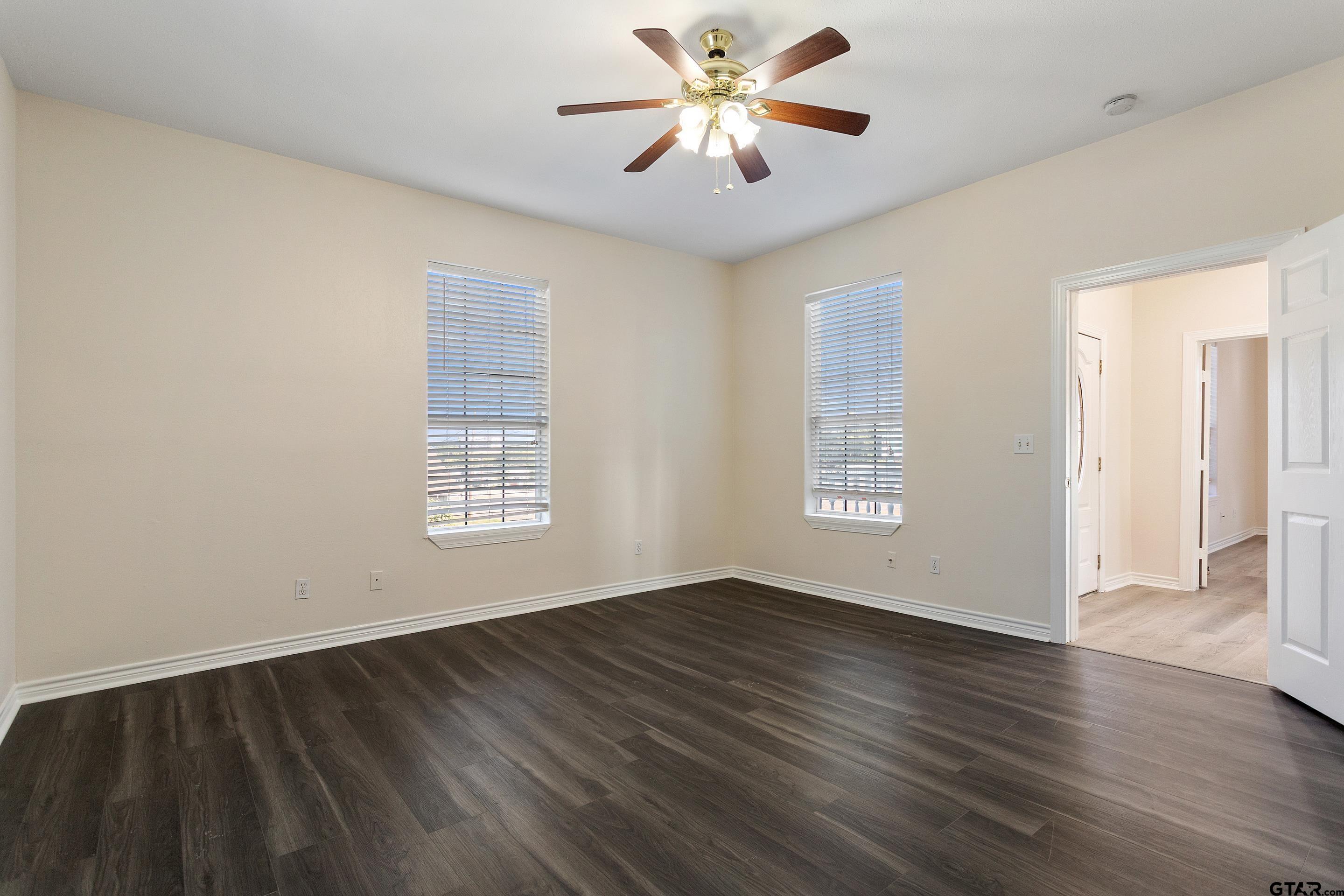 1002 North Normandy Avenue Tyler, TX 75702 - Photo 37 of 41 a view of an empty room with window and wooden floor