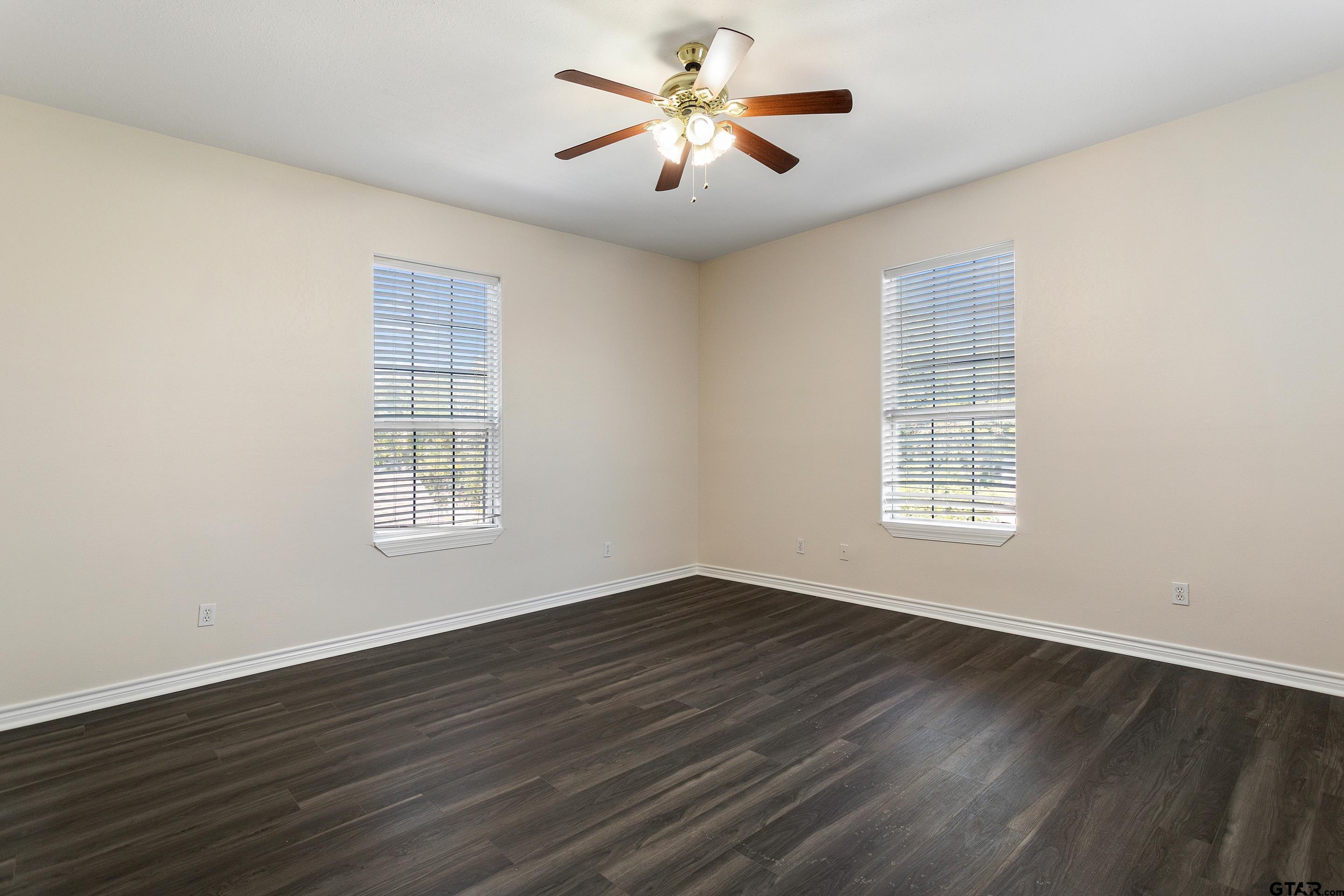 1002 North Normandy Avenue Tyler, TX 75702 - Photo 38 of 41 a view of an empty room with a window and wooden floor