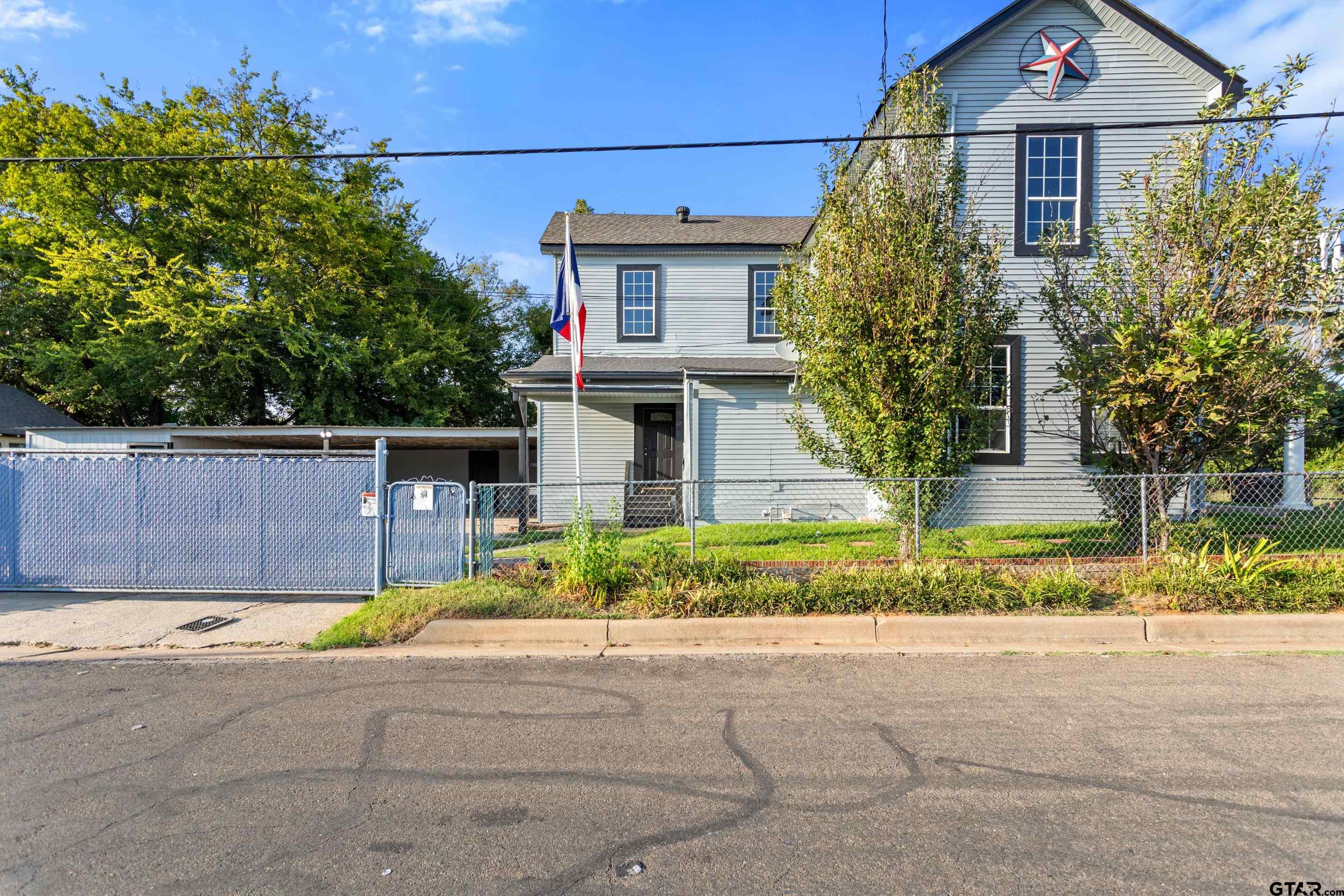 1002 North Normandy Avenue Tyler, TX 75702 - Photo 6 of 41 front view of a house with a street