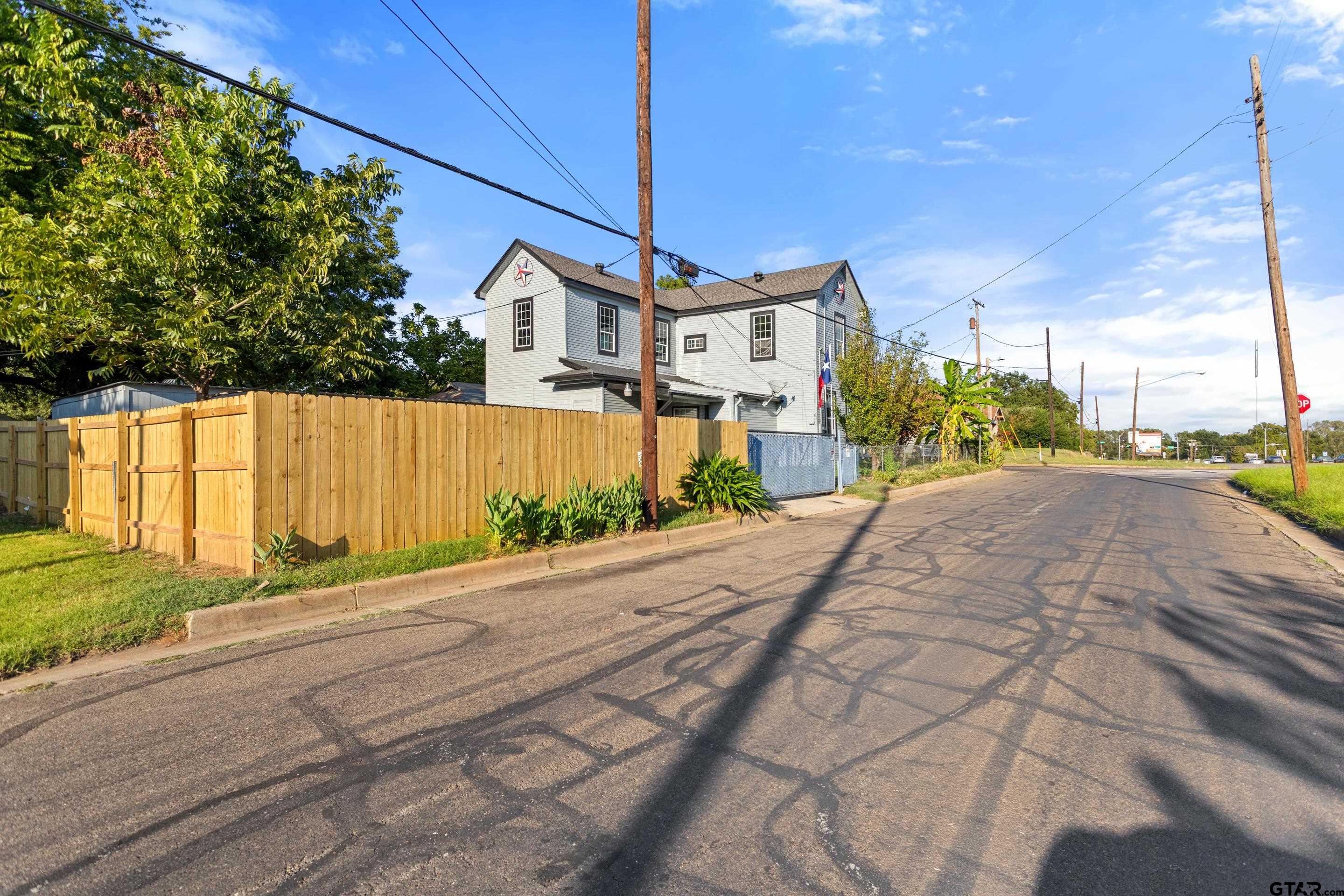 1002 North Normandy Avenue Tyler, TX 75702 - Photo 7 of 41 a front view of a house with a yard and garage