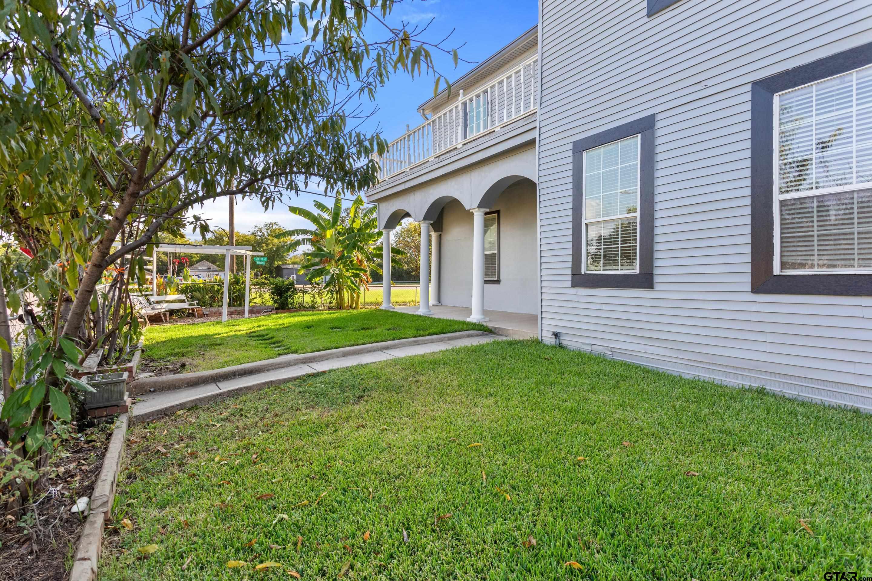 1002 North Normandy Avenue Tyler, TX 75702 - Photo 8 of 41 a front view of a house with garden