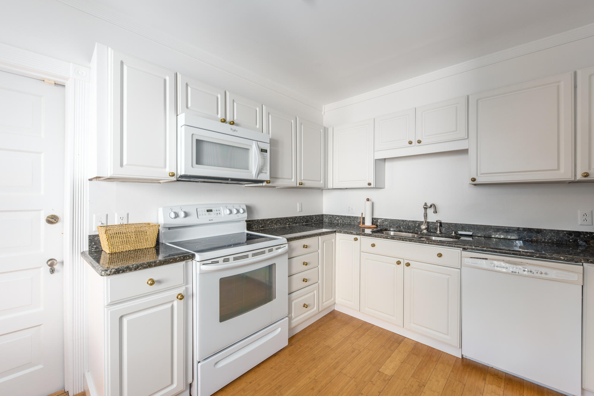 5 North Beach Road Hobe Sound, FL 33455 - Photo 13 of 26 a kitchen with granite countertop white cabinets and white appliances