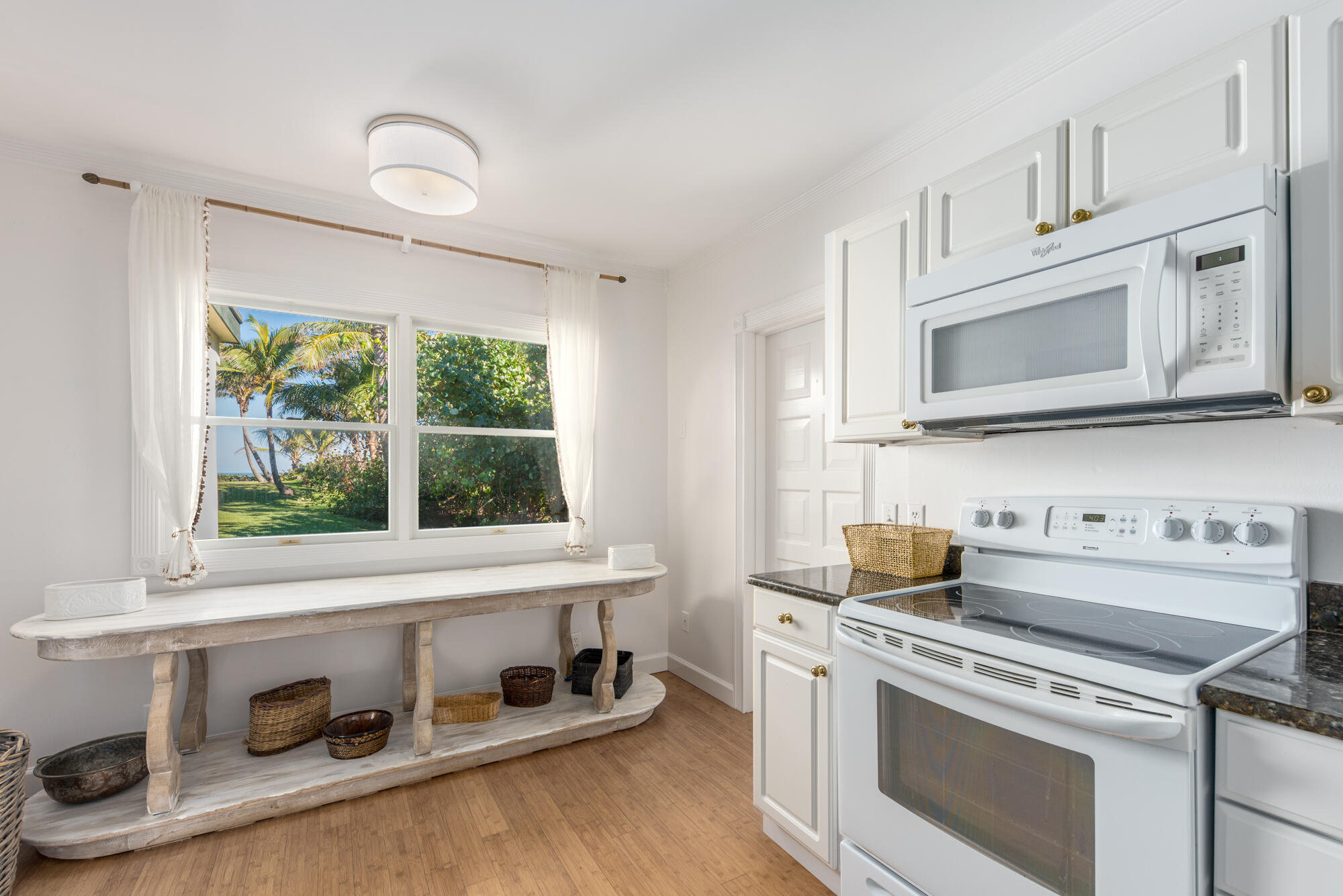 5 North Beach Road Hobe Sound, FL 33455 - Photo 14 of 26 a kitchen with appliances cabinets and a wooden floor