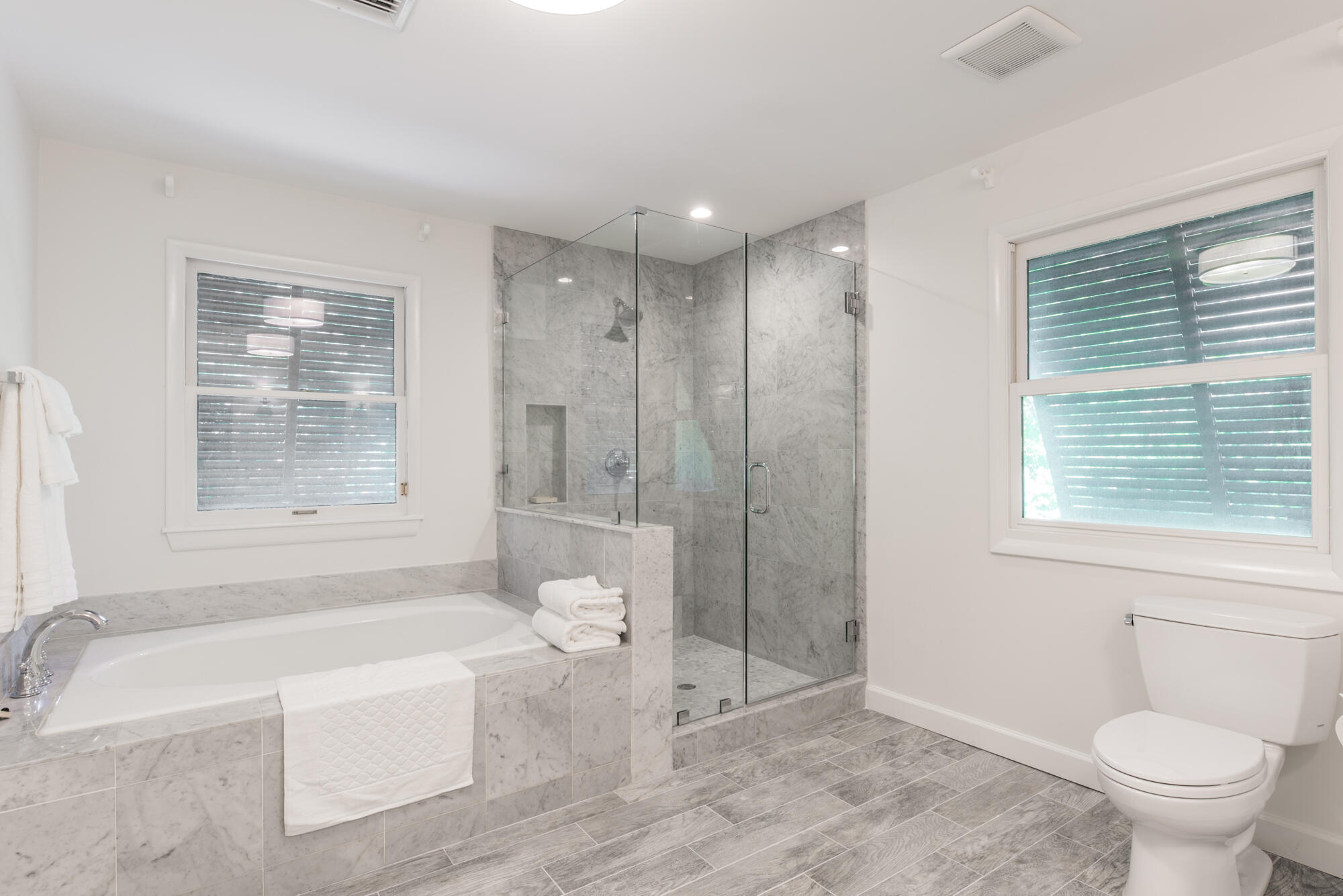 5 North Beach Road Hobe Sound, FL 33455 - Photo 19 of 26 a bathroom with a tub a toilet and a shower