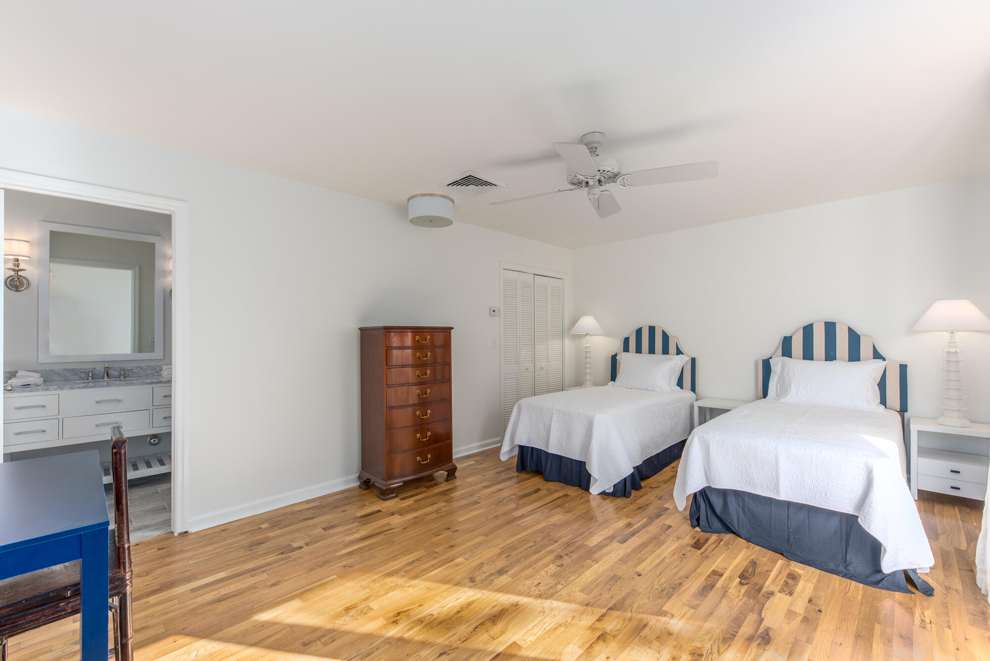 5 North Beach Road Hobe Sound, FL 33455 - Photo 23 of 26 a spacious bedroom with two bed and a chandelier