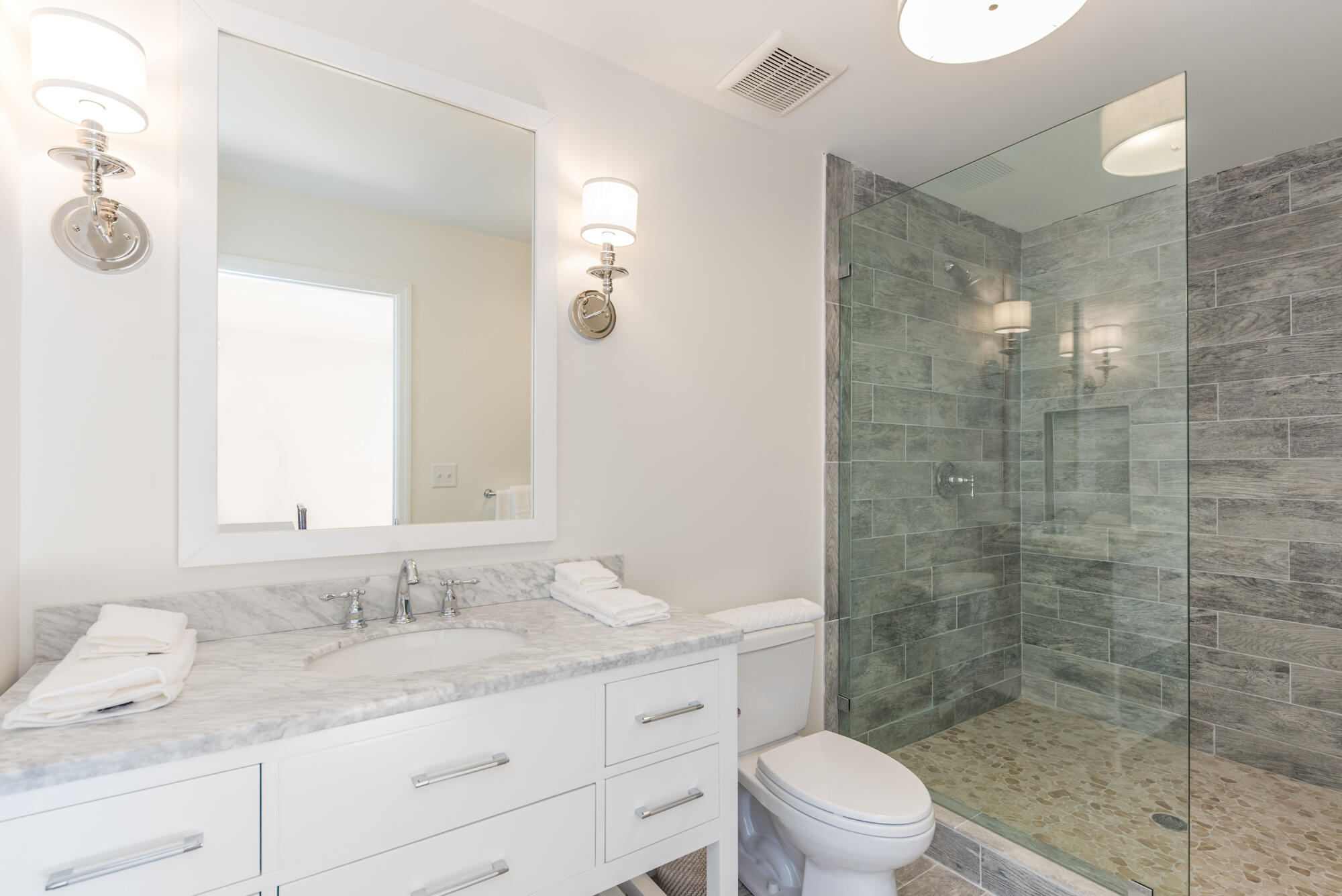 5 North Beach Road Hobe Sound, FL 33455 - Photo 24 of 26 a bathroom with a granite countertop sink a toilet a mirror and shower